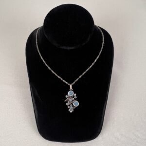 Double edelweiss necklace with light blue stones.
